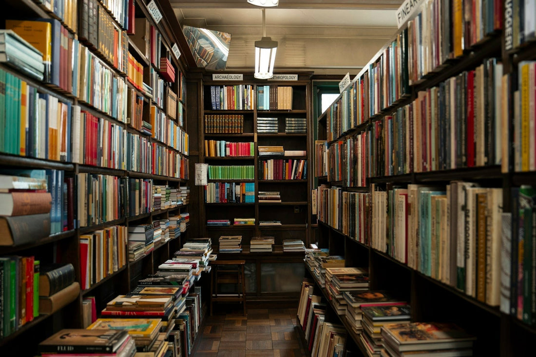 Rows of books filling floor-to-ceiling shelves in a bookshop