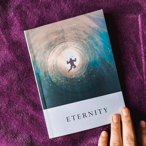 Book titled 'Eternity' on a purple textured surface with a hand holding it.
