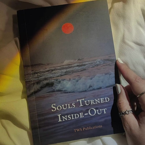 Book titled 'Souls Turned Inside-Out' by TWS Publications held by a hand.
